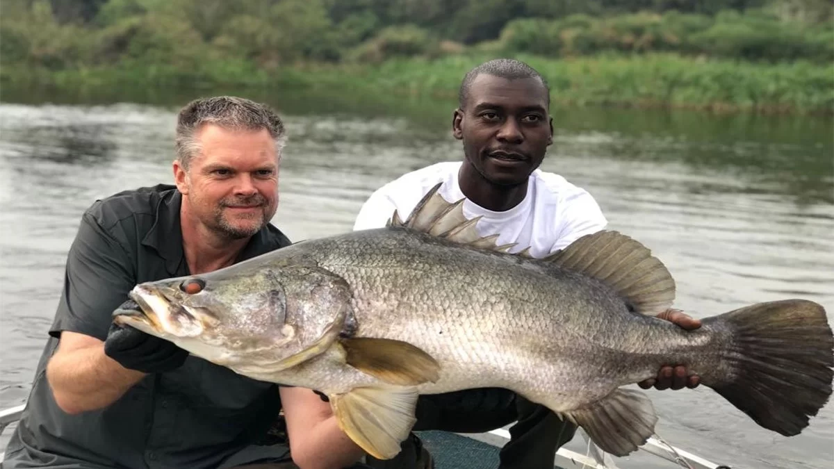 Fishing guide supporting a client -Pieland Gorilla Safaris 