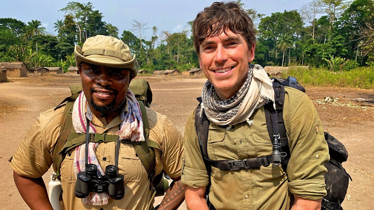 A tourist and a guide in the lowland equatorial rainforest ready for Bonobo Tracking in Congo Safari Adventures with Pieland Gorilla Safaris.