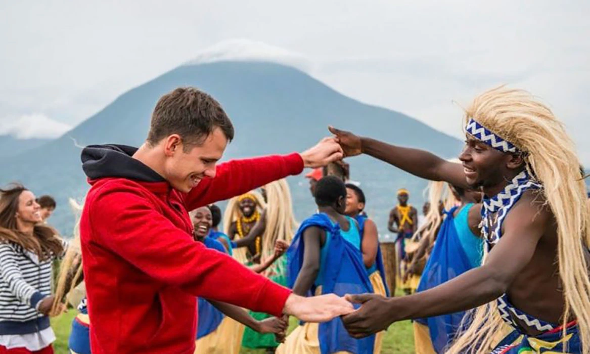 A tourist getting engaged in cultural entertainment in Rwanda.
