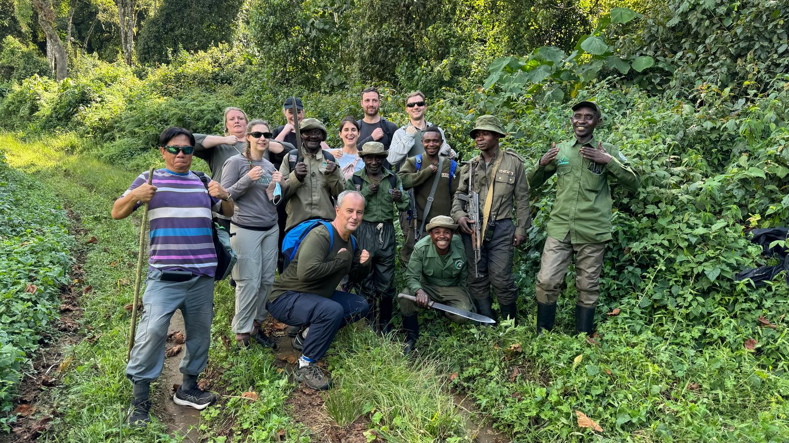 Tourists on a forest walk while doing bonobo tracking in Congo safari adventures exploring dense tropical rainforests guided by local trackers in search of endangered bonobos. The experience offers close encounters with unique primates, rich birdlife, and untouched Congo wilderness, creating an authentic and unforgettable rainforest safari adventure.