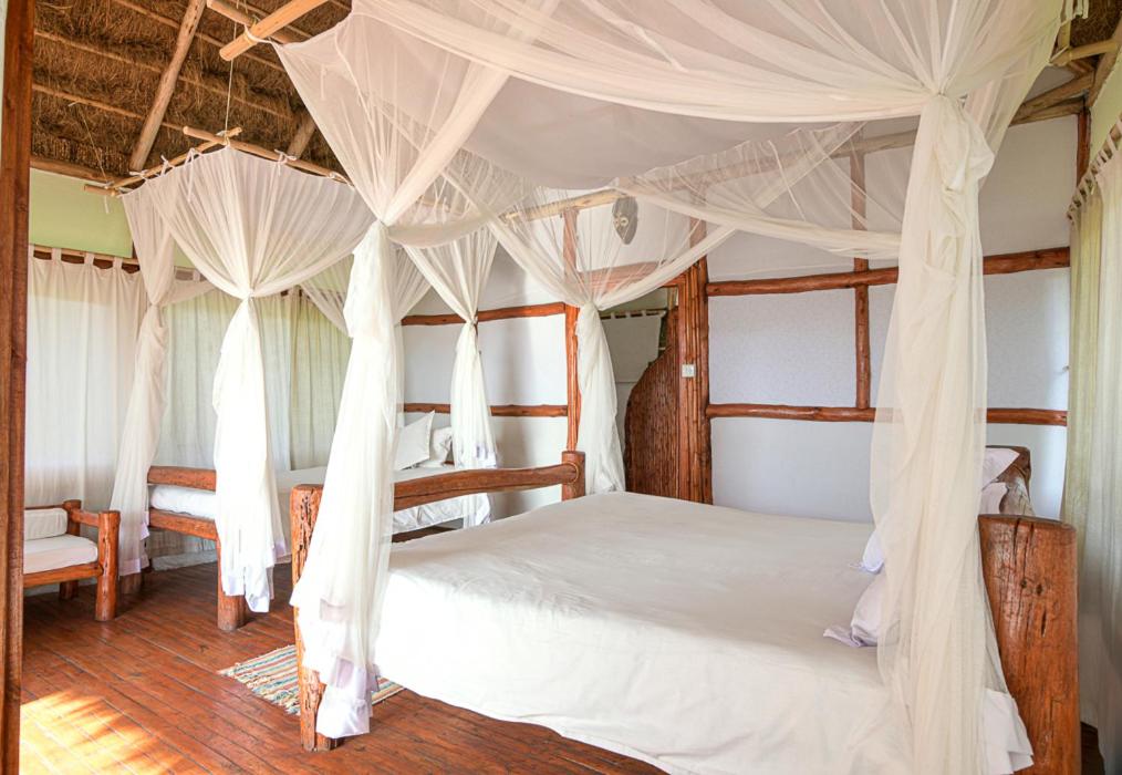 Kazinga Wilderness Safari Camp is a charming, eco-friendly retreat in Queen Elizabeth National Park, offering stunning views of the Kazinga Channel. With comfortable tented accommodation, it provides easy access to thrilling game drives and boat safaris. Perfect for those seeking an authentic safari experience with Pieland Gorilla Safaris.
