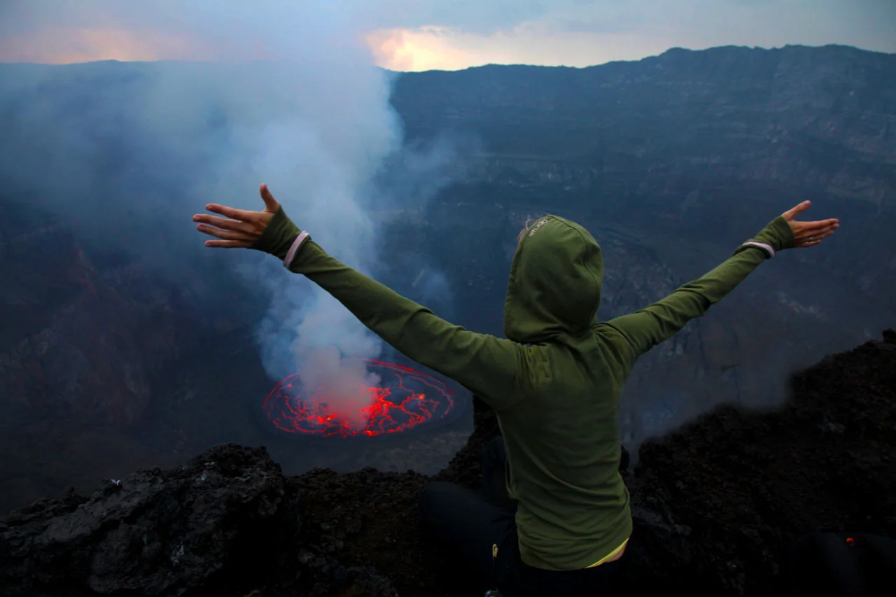 A tourist watching the beautiful views of Mountain Nyiragongo which is one of the best Congo tour safari deals.