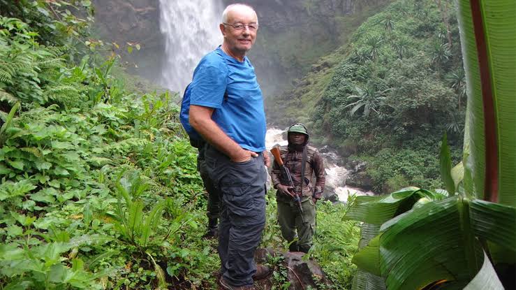 A happy tourist enjoying his hiking safari with Pieland Gorilla Safaris.
