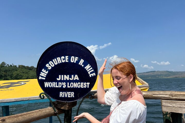 Tourists standing at the exact point where the longest river in the World starts from during their 22 days ultimate Uganda and Rwanda safari with Pieland Gorilla Safaris.