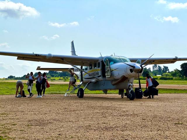 Tourists disembarking the aircraft during their fly-in safari in Uganda.