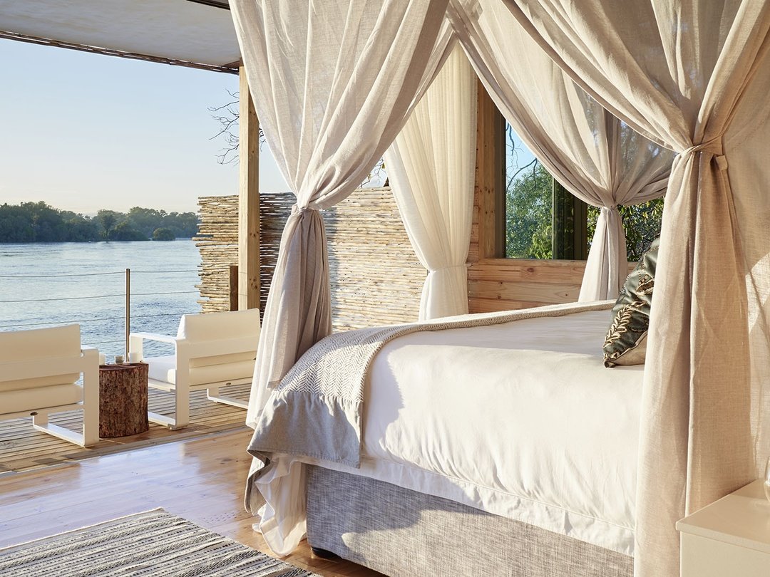 Victoria Falls River Lodge is one of the best luxury accommodation options in Victoria Falls for travelers seeking privacy, comfort, and a genuine wilderness experience. Set along the banks of the Zambezi River, the lodge combines elegant rooms, beautiful river views, refined dining, and peaceful surroundings close to nature. Guests can enjoy relaxing moments at the lodge while also joining Victoria Falls tours, sunset cruises, and wildlife activities in the surrounding area. It is especially suitable for honeymooners, couples, families, and luxury safari travelers who want an exclusive stay that blends high-end comfort with the natural beauty of Victoria Falls.