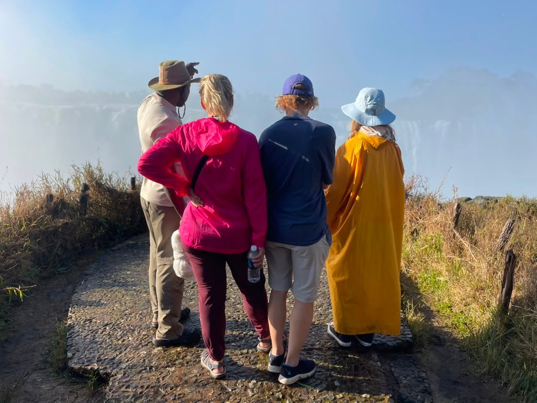 Tourists standing near Victoria Falls on the Zimbabwean side enjoy breathtaking views of the mighty Zambezi River as it plunges into the dramatic gorge below on a trip organized by Pieland Gorilla Safaris. From the scenic viewpoints, visitors can admire the immense curtain of falling water, rising mist, colorful rainbows, and lush rainforest surrounding the falls. The Zimbabwean side offers some of the most impressive panoramic perspectives, making it ideal for photography and sightseeing. The powerful sound of the water and the cool spray create an unforgettable atmosphere, making this one of the most remarkable highlights of a Southern African safari.