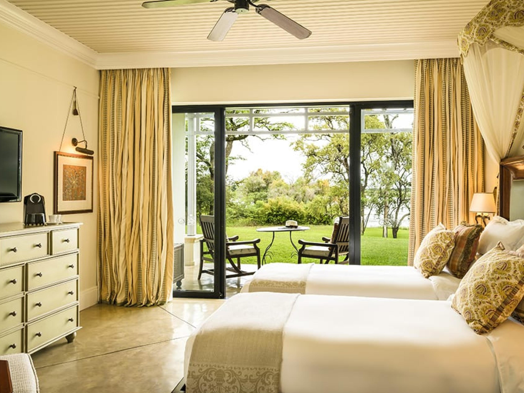Royal Livingstone Hotel in Livingstone, Zambia, offers travelers a peaceful and elegant stay during a safari to Victoria Falls with Pieland Gorilla Safaris. Set close to the Zambezi River and within easy reach of the falls, the hotel provides a relaxing atmosphere surrounded by beautiful gardens and natural scenery. Guests can unwind in comfortable rooms, enjoy quality dining, and experience convenient access to Victoria Falls activities on the Zambian side. Its tranquil setting makes it especially suitable for couples, families, and luxury travelers who want to combine sightseeing and safari adventures with comfort, privacy, and restful accommodation.
