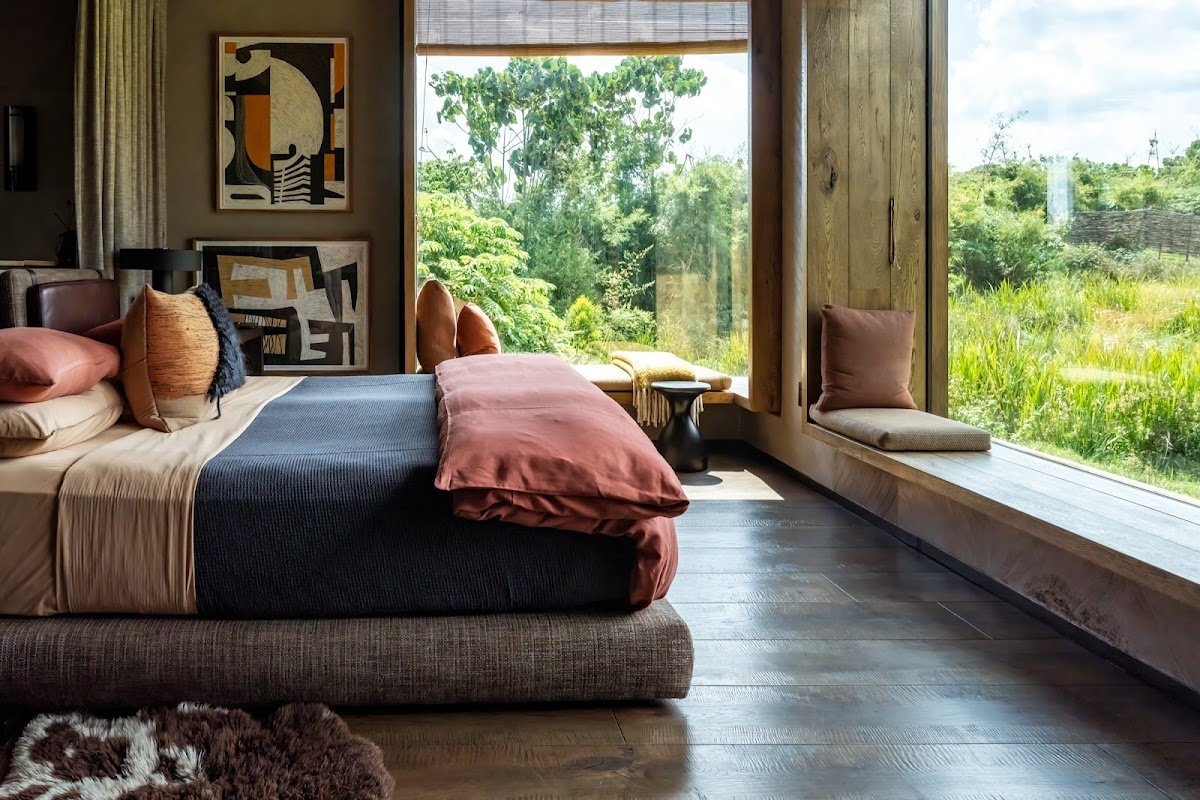 Singita Kwitonda Lodge is an exceptional luxury accommodation near Rwanda’s Volcanoes National Park, sharing a 1.2-kilometre border with the park and offering beautiful views of the Sabyinyo, Gahinga and Muhabura volcanoes. The lodge provides a peaceful setting where guests can relax before and after visiting the mountain gorillas. Its design combines contemporary comfort with locally inspired craftsmanship, while wellness experiences, farm-to-table dining and a dedicated Gear Room enhance the stay. For travelers seeking privacy, comfort and close proximity to the gorilla habitat, Singita Kwitonda is one of Rwanda’s outstanding high-end safari lodges.