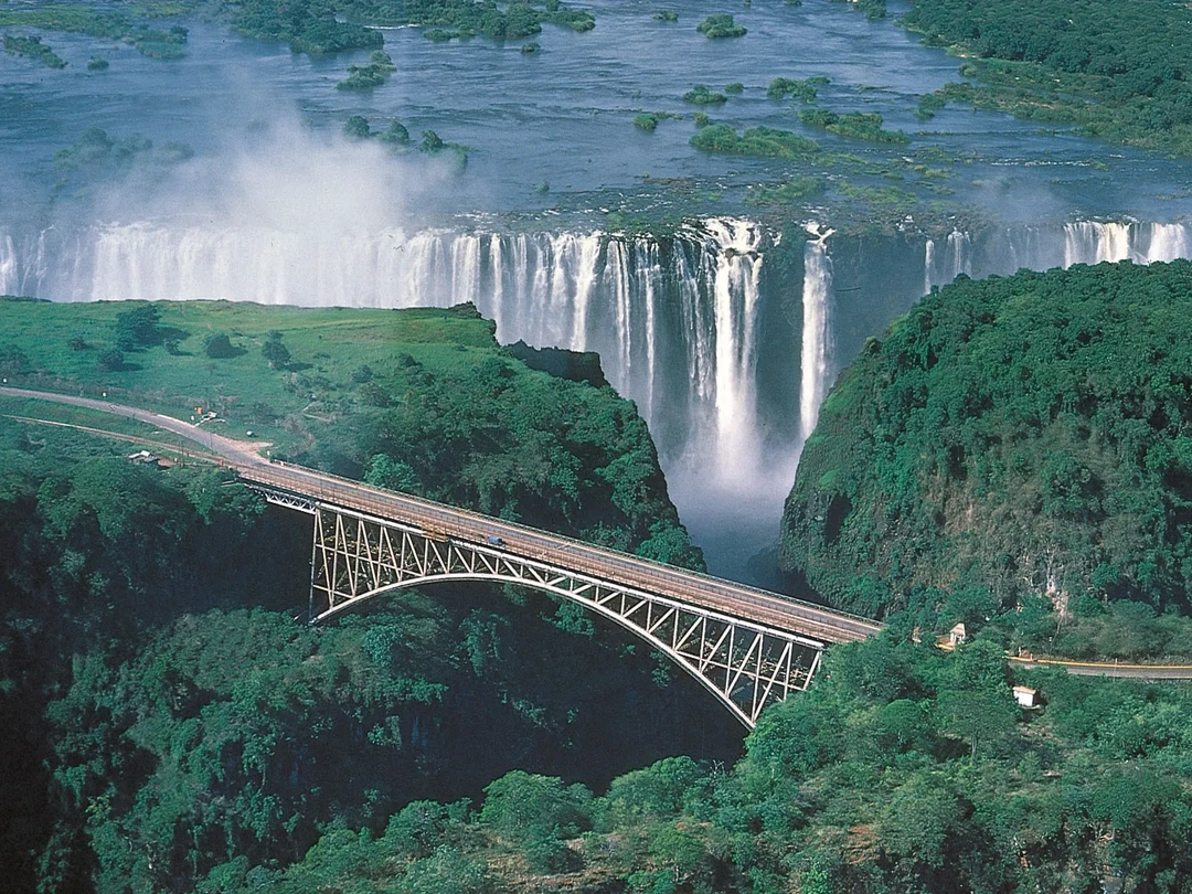 The Victoria Falls Bridge is an important landmark on a safari to Victoria Falls with Pieland Gorilla Safaris, connecting Zimbabwe and Zambia across the dramatic Zambezi Gorge. The bridge offers spectacular views of the surrounding cliffs, rising mist, and sections of Victoria Falls, making it a memorable stop for sightseeing and photography. It also plays a practical role for travelers who want to experience both the Zimbabwean and Zambian sides of the falls during the same journey. Beyond its transport importance, the bridge is associated with adventure activities such as bungee jumping, adding excitement to a well-planned Victoria Falls safari.