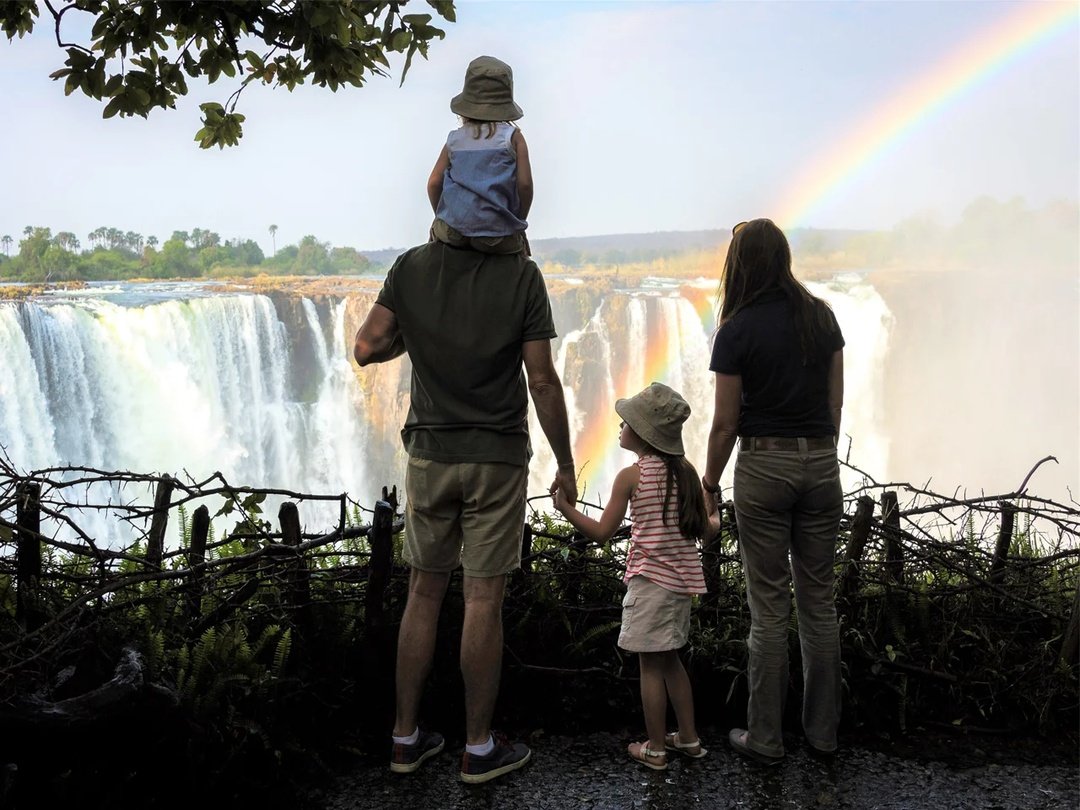 Tourists stand in awe as they enjoy the breathtaking views of Victoria Falls, one of the world’s greatest natural wonders. Surrounded by mist, rainbows, and the powerful sound of cascading waters, visitors capture unforgettable moments while experiencing the beauty, adventure, and magnificent scenery of this iconic African landmark.