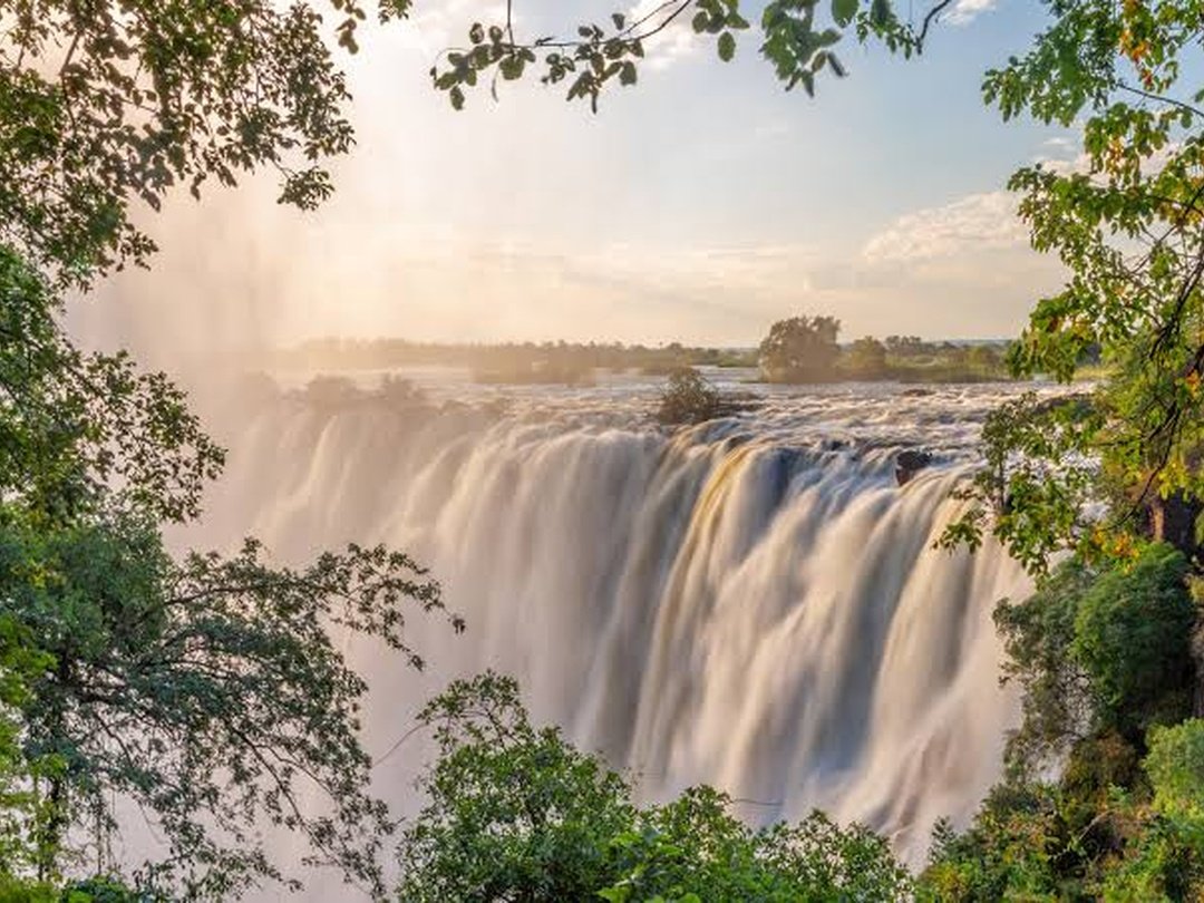 High water levels at Victoria Falls create one of the most dramatic natural spectacles in Africa. During this period, enormous volumes of the Zambezi River plunge over the falls, producing powerful cascades, thunderous sounds, and thick clouds of mist that rise high above the gorge. The surrounding rainforest becomes lush and vibrant, while sunlight often creates beautiful rainbows across the spray. From the viewing points, travelers can feel the force of the water and may become soaked by the mist. High-water conditions reveal Victoria Falls at its most powerful, impressive, and unforgettable, creating exceptional scenery for sightseeing and photography.