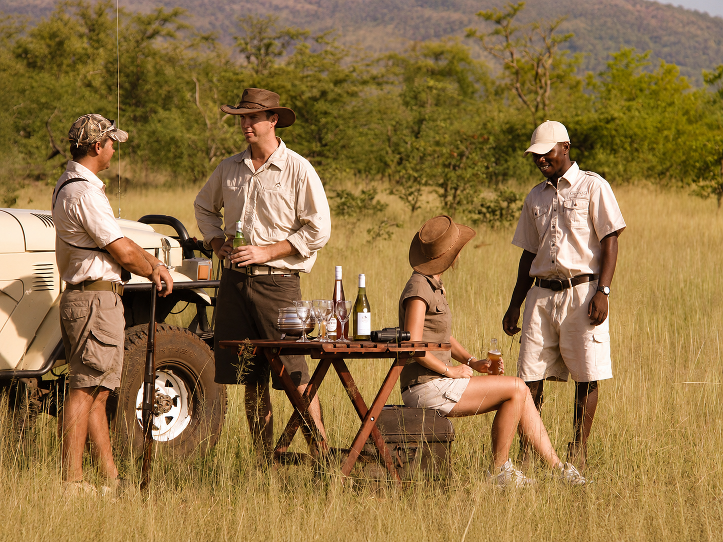Tourists are dressed in suitable safari wear as they enjoy their day trip to Chobe National Park with Pieland Gorilla Safaris. Their lightweight, neutral-colored shirts, shorts, hats, and comfortable footwear are ideal for warm conditions and outdoor wildlife activities. The practical clothing allows easy movement during game drives while helping travelers remain comfortable throughout the safari. Wide-brimmed hats and caps also provide protection from the strong African sun. Dressing appropriately adds to the enjoyment of the experience, allowing visitors to focus on Chobe’s beautiful landscapes and wildlife. Pieland Gorilla Safaris encourages travelers to choose comfortable, breathable, and practical safari clothing.