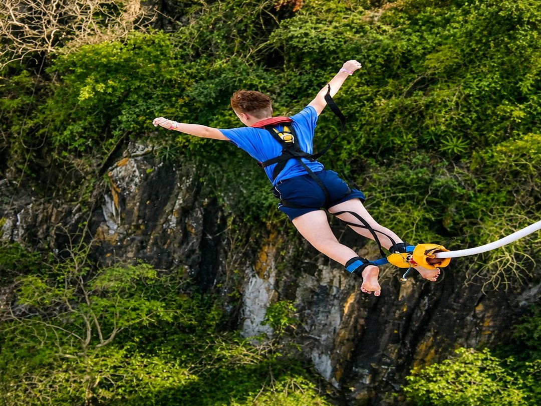 A tourist takes on the thrilling adventure of bungee jumping at Victoria Falls, experiencing an adrenaline-filled leap above the mighty Zambezi River. Suspended from the historic Victoria Falls Bridge, the jump offers breathtaking views of the gorge, rushing waters, and surrounding landscapes. This unforgettable activity attracts adventure seekers looking for excitement and a once-in-a-lifetime experience at one of Africa’s most iconic destinations.