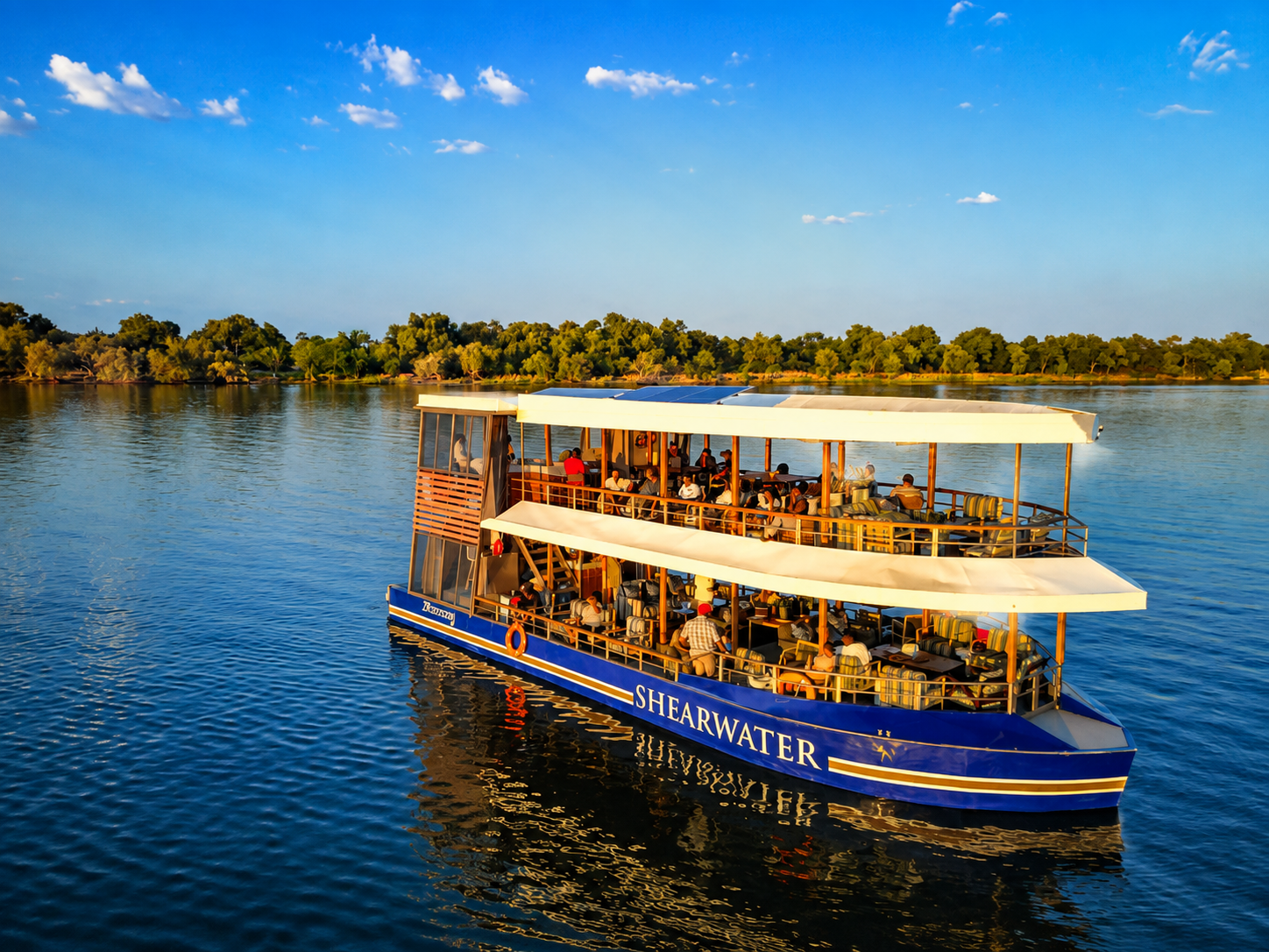 Family enjoying a Zambezi sunset cruise during a Victoria Falls Family Safari in Zimbabwe.