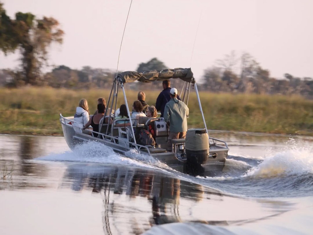 Tourists enjoying a boat safari through the waterways of the Okavango Delta in Botswana