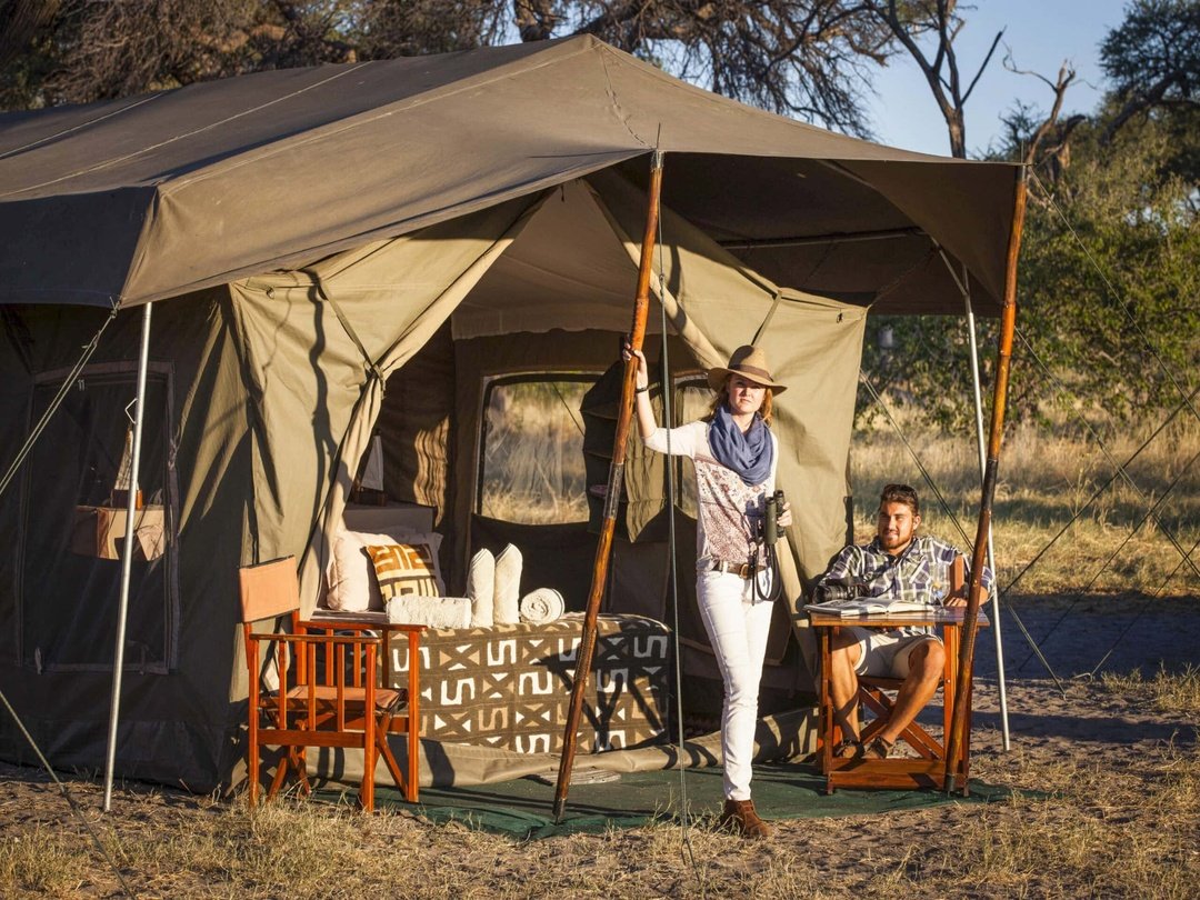 Tourists enjoying a mobile camping safari adventure in the Okavango Delta Botswana wilderness