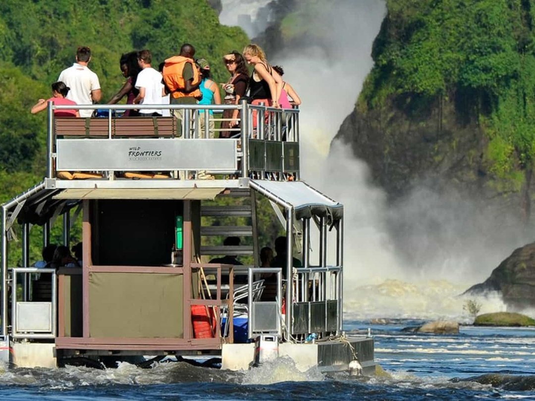 Tourists enjoying a boat safari in Murchison Falls National Park during a Uganda safari combined with a stay at Little Monkey Camp near Kibale National Park.
