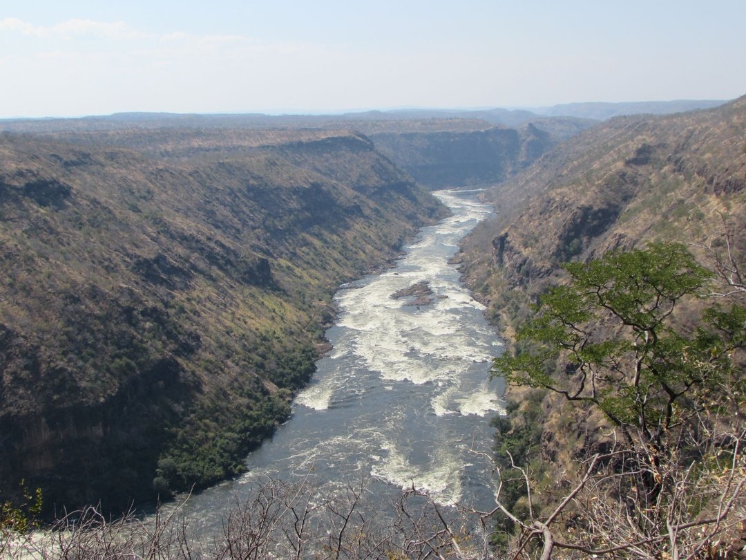 Aerial view of Batoka Gorge with the Zambezi River flowing through steep rocky cliffs below Victoria Falls.