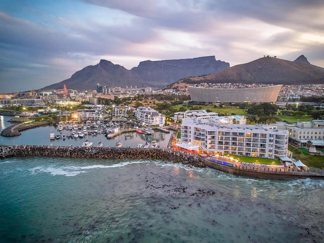 Cape Town, South Africa, with Table Mountain overlooking the waterfront and city skyline along the Atlantic Ocean.