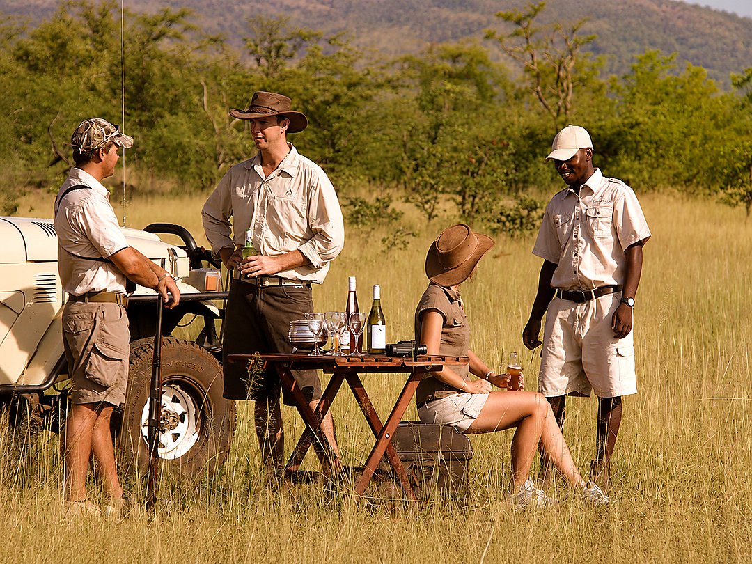 Tourists wearing practical safari clothing during a Zambezi National Park safari.