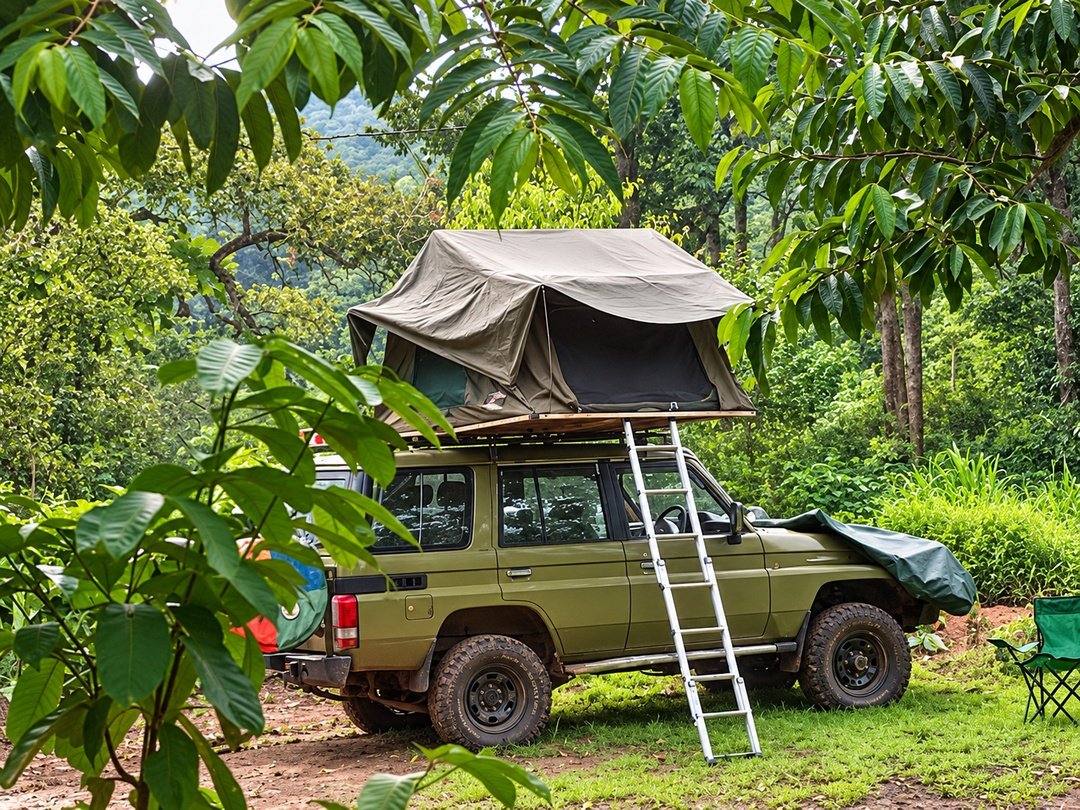 Tourists camping in Kibale National Park with a rooftop safari tent surrounded by lush tropical forest in western Uganda.