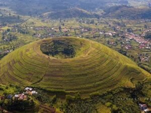 Aerial view of a volcanic crater hill surrounded by green farmland in Kisoro, southwestern Uganda.